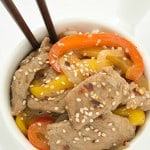 A delicious spicy sesame beef stir fry recipe that can be made in 30 minutes! Loaded with tons of fresh bell peppers and onions.