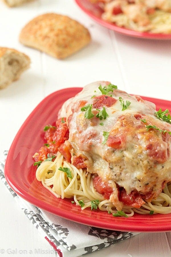 Easy Chicken Parmesan: Moist and juicy chicken breasts coasted in breadcrumbs, mixed with Italian seasonings; then topped with diced tomatoes, Parmesan cheese, and fresh mozzarella.