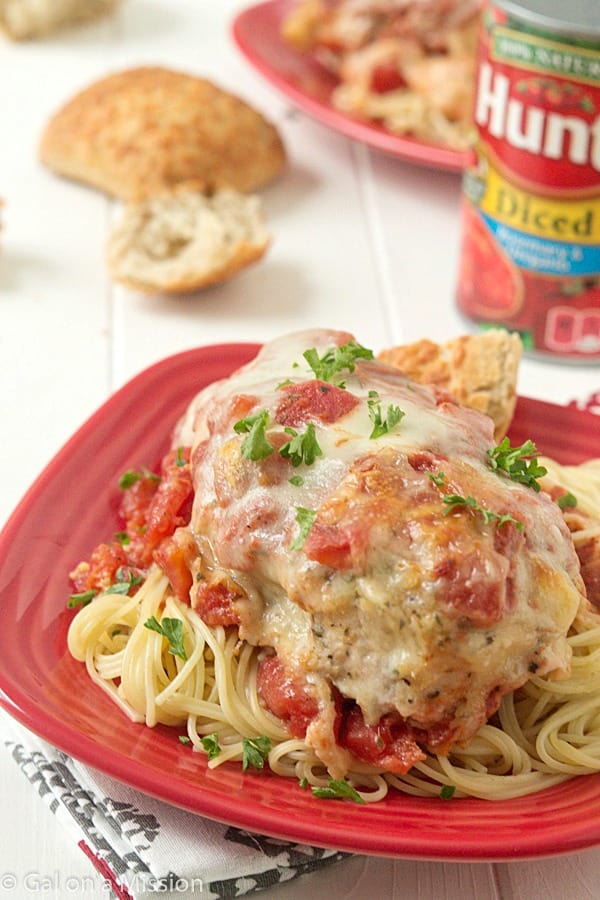 Easy Chicken Parmesan: Moist and juicy chicken breasts coasted in breadcrumbs, mixed with Italian seasonings; then topped with diced tomatoes, Parmesan cheese, and fresh mozzarella.