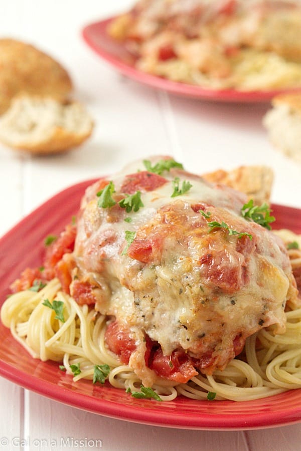 Easy Chicken Parmesan: Moist and juicy chicken breasts coasted in breadcrumbs, mixed with Italian seasonings; then topped with diced tomatoes, Parmesan cheese, and fresh mozzarella.