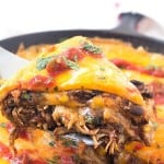 Mexican Skillet Pie - Also known as a Mexican skillet casserole. Layered with tortillas, enchilada sauce with black beans and corn, and taco-seasoned shredded chicken! Our family also likes to call it a Mexican skillet dinner - we always seem to have it for dinner and makes quite a bit! Perfect dish to add to your Cinco de Mayo recipes!