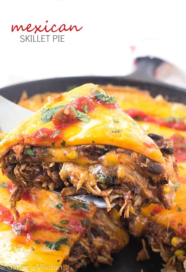 Mexican Skillet Pie - Also known as a Mexican skillet casserole. Layered with tortillas, enchilada sauce with black beans and corn, and taco-seasoned shredded chicken! Our family also likes to call it a Mexican skillet dinner - we always seem to have it for dinner and makes quite a bit! Perfect dish to add to your Cinco de Mayo recipes!
