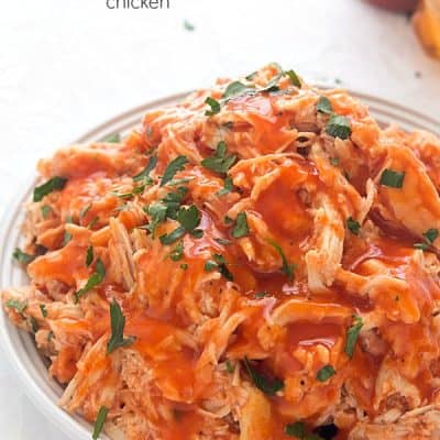 Slow Cooker Honey Sriracha Chicken - Moist and tender chicken in an out-of-this-world sauce! Perfect for sandwiches, tacos or even on top of salads!