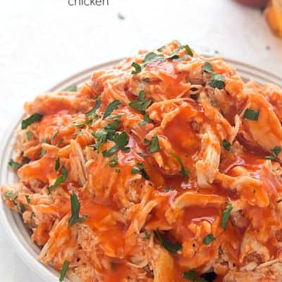 Slow Cooker Honey Sriracha Chicken - Moist and tender chicken in an out-of-this-world sauce! Perfect for sandwiches, tacos or even on top of salads!