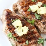 Grilled Jerk Pork Chops - Flavorful and delicious! Perfect as a main entree or on top of a big salad. Best when served with fresh or canned pineapple chunks!