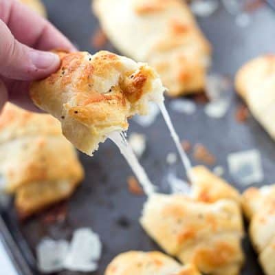 Cheesy Parmesan Crusted Crescent Rolls - Stuffed with mozzarella cheese, then slathered with butter and Italian spices, and then topped with parmesan cheese! Baked to cheesy perfection.