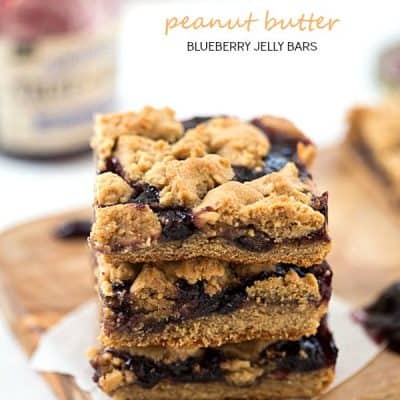 Peanut Butter and Blueberry Jelly Bars - Perfectly soft peanut butter dough base, then topped with blueberry jelly, and finished with peanut butter dough crumbled on top!