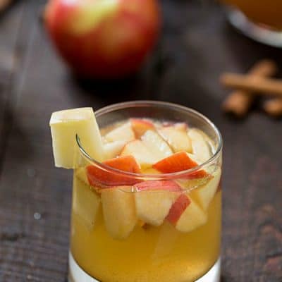 Apple Sangria - The perfect cocktail for busy holidays to relax with friends and family. Hints of honey crisp apples, caramel, apple cider, and cinnamon!