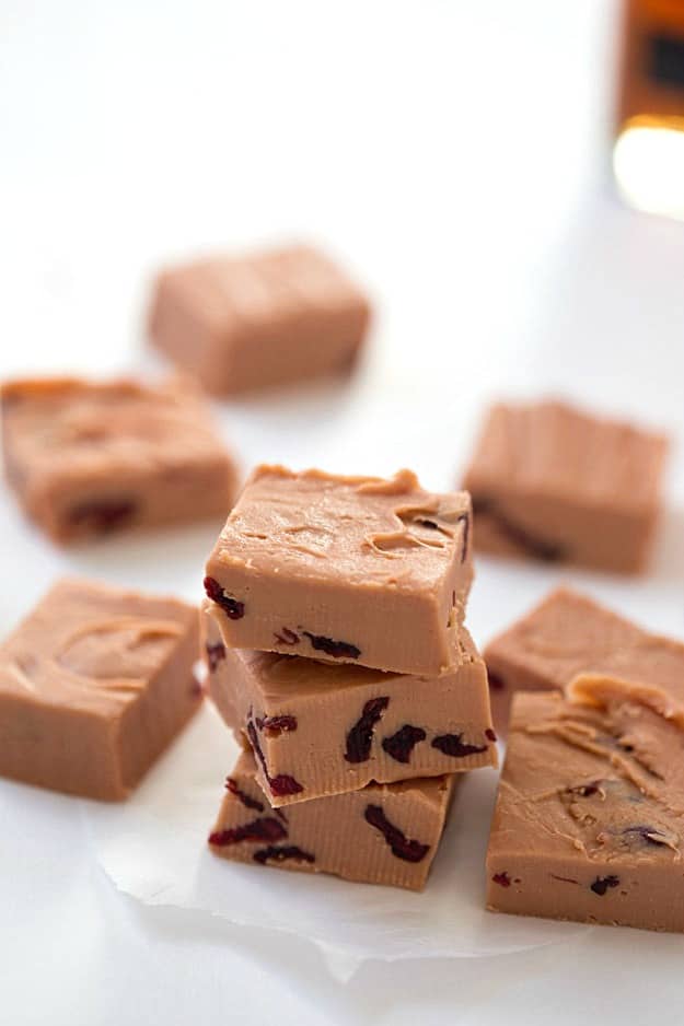 Buttered Rum Fudge with Cranberries - Melts right in your mouth! Dried cranberries scattered throughout each piece, then finished with even more dried cranberries and pecans. Not your momma's kind of fudge! This kind of fudge blows the pants off fudge brownies!