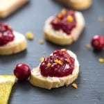 Cranberry Orange Crostini - A decadent crostini made with an out-of-this-world cheese spread, then topped with fresh cranberry sauce and orange zest! Perfect appetizer for the holidays.