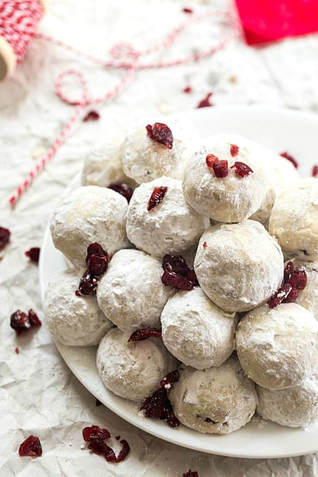 Snowball Cookies with Cranberries Recipe - They are so easy and perfect for Christmas! Made with pecans and dried cranberries. Skip the chocolate this year and make snowball cookies!
