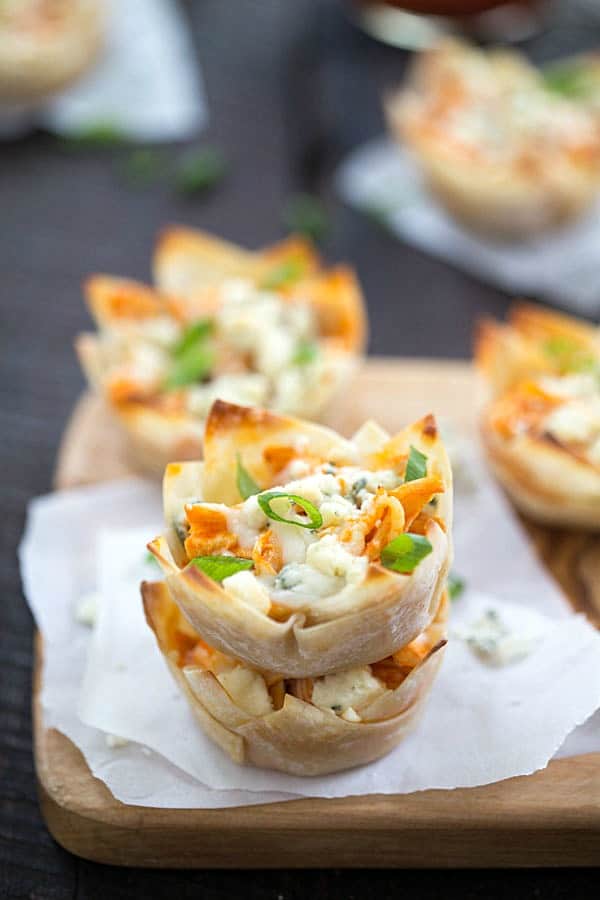 Cheesy Buffalo Chicken Cups Recipe - Tender chicken seasoned with the best hot sauce, then topped with cheesy mozzarella cheese, then finished with crumbled blue cheese! One of our favorite appetizers for a party! If you like buffalo wings, buffalo chicken dip, or pasta you are going to love this!