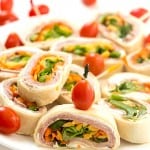 Ham and Veggie Pinwheels - Layered with black forest ham, shredded carrots, sliced green peppers, and topped with romaine lettuce. Perfect as appetizers for a party or a delicious and healthy lunch! These adorable bite-sized little "sandwiches" are so good!