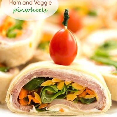 Ham and Veggie Pinwheels - Layered with black forest ham, shredded carrots, sliced green peppers, and topped with romaine lettuce. Perfect as appetizers for a party or a delicious and healthy lunch! These adorable bite-sized little "sandwiches" are so good!