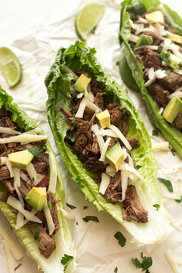 Slow Cooker Barbacoa Taco Lettuce Wraps - Takes 5 minutes to prep in the crockpot and creates the most tender and juiciest homemade barbacoa! Flavored with the traditional barbacoa flavors: garlic, oregano, cumin; including chipotles in adobo! The not historically known authentic recipe, but oh, so delicious! Takes no time to assemble these lettuce wraps. Perfect for a lighter and low-carb option!