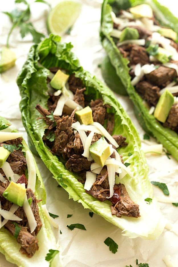 Slow Cooker Barbacoa Taco Lettuce Wraps - Takes 5 minutes to prep in the crockpot and creates the most tender and juiciest homemade barbacoa! Flavored with the traditional barbacoa flavors: garlic, oregano, cumin; including chipotles in adobo! The not historically known authentic recipe, but oh, so delicious! Takes no time to assemble these lettuce wraps. Perfect for a lighter and low-carb option!