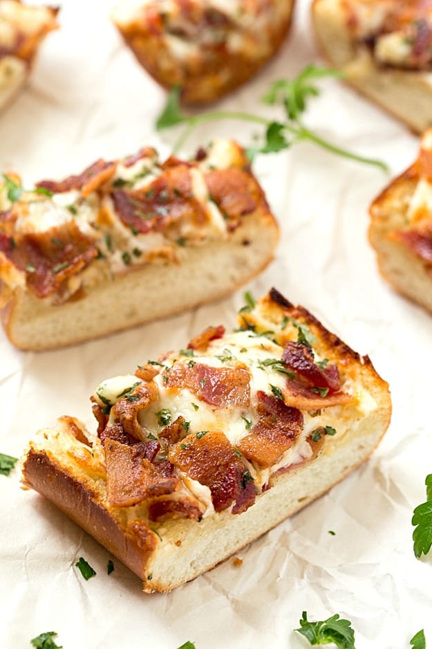 Cheesy Bacon Ranch Garlic Bread - Not just another cheesy garlic bread recipe! This bread is fantastic, and we were able to stop eating it! With a few changes, you can have homemade, and this easy garlic bread is taken to a whole new level! The best garlic spread with the addition of ranch seasoning!