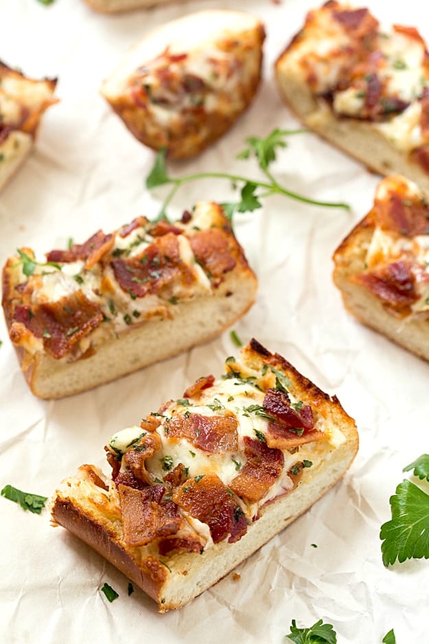 Cheesy Bacon Ranch Garlic Bread - Not just another cheesy garlic bread recipe! This bread is fantastic, and we were able to stop eating it! With a few changes, you can have homemade, and this easy garlic bread is taken to a whole new level! The best garlic spread with the addition of ranch seasoning!