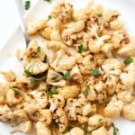 Roasted Thai Chili Cauliflower Bites Recipe - Oven baked and roasted! Make dinner a breeze with these 2-ingredient cauliflower bites! So much flavor and incredibly easy. Serve as an appetizer or as a side dish; even the kids love them! Tender and bursting with the perfect flavor of sweet and spicy.