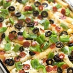 Supreme Pizza Baked Fries Recipe - A super fun twist on plain baked fries! Bursting with mozzarella cheese, mini pepperoni, black olives, and diced green bell peppers! The ultimate loaded comfort food! So easy they can be made in 15 minutes!