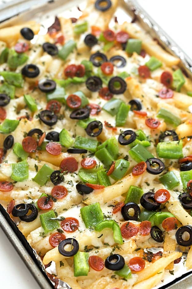 Supreme Pizza Baked Fries Recipe - A super fun twist on plain baked fries! Bursting with mozzarella cheese, mini pepperoni, black olives, and diced green bell peppers! The ultimate loaded comfort food! So easy they can be made in 15 minutes!