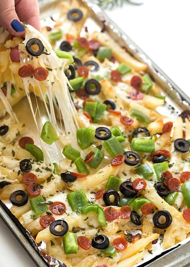 Supreme Pizza Baked Fries Recipe - A super fun twist on plain baked fries! Bursting with mozzarella cheese, mini pepperoni, black olives, and diced green bell peppers! The ultimate loaded comfort food! So easy they can be made in 15 minutes!