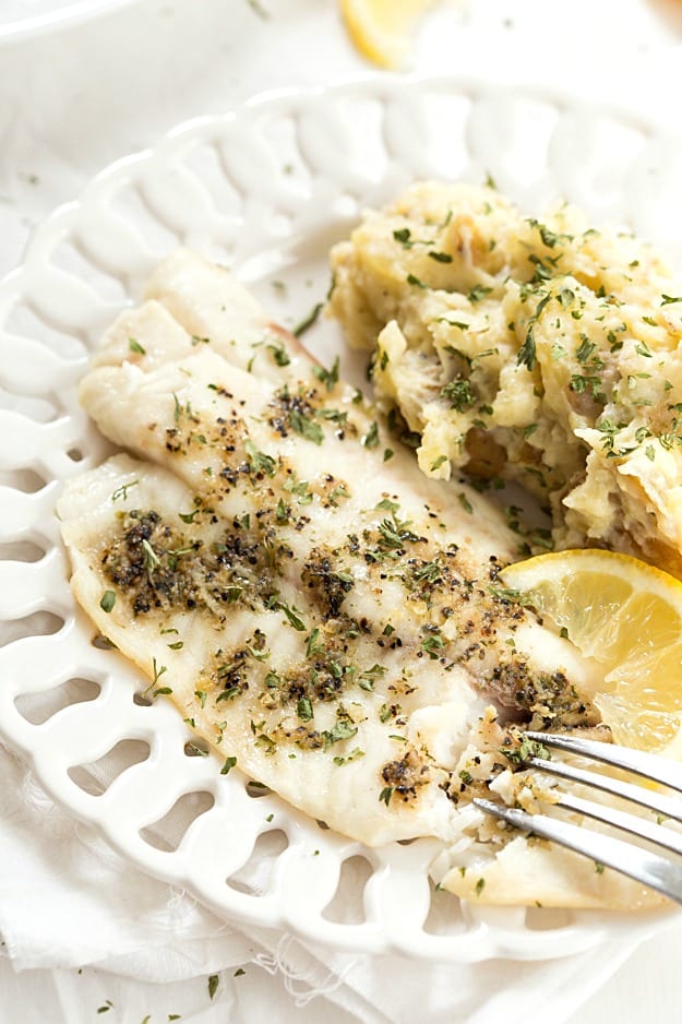 Tilapia & Crockpot Lemon Garlic Mashed Potatoes - An incredibly easy and healthy meal that's no fuss or mess and baked to perfection! Paired perfectly with fresh lemon and garlic flavors! The mashed potatoes can be made with yellow or red potatoes!