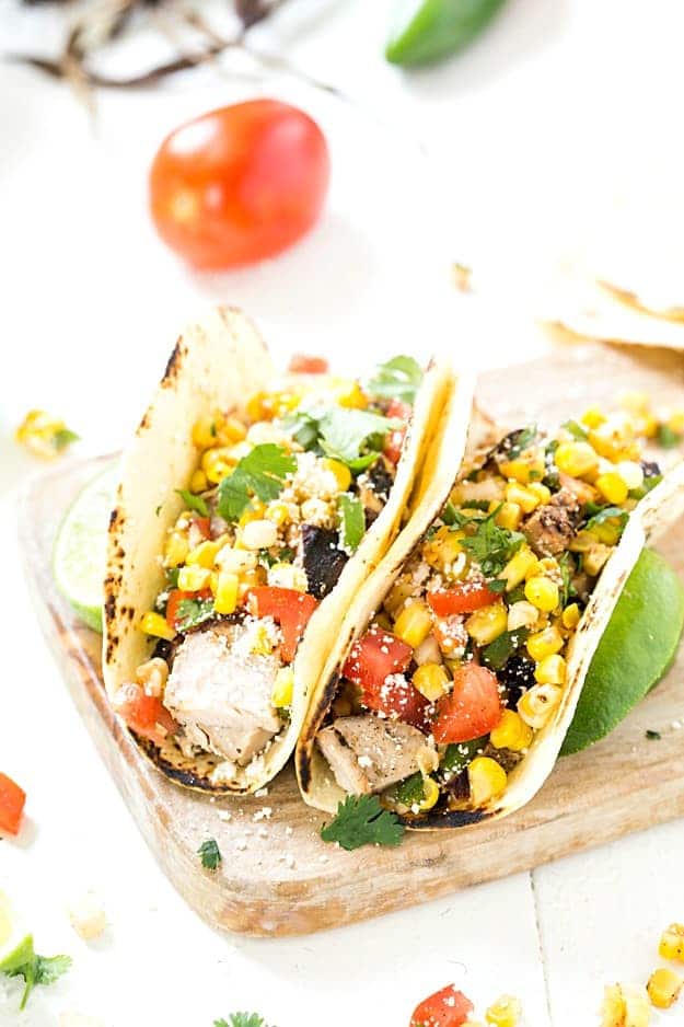 Grilled Pork Tacos with Mexican Corn Salsa - Pork tenderloin marinated to perfect and smothered with an incredible Mexican corn salsa. The corn salsa is so good you may even spoon it directly into your mouth! Everyday of the week easy!