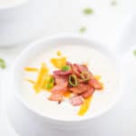 Copycat Panera Baked Potato Soup - The easiest baked potato soup ever! Diced russets potatoes are simmered in the best seasonings and spices with bacon in a rich cream sauce topped with green onions, more bacon, and shredded cheese! It's everything you want in a baked potato soup. It's rich; it's creamy and easy! Better than the original!