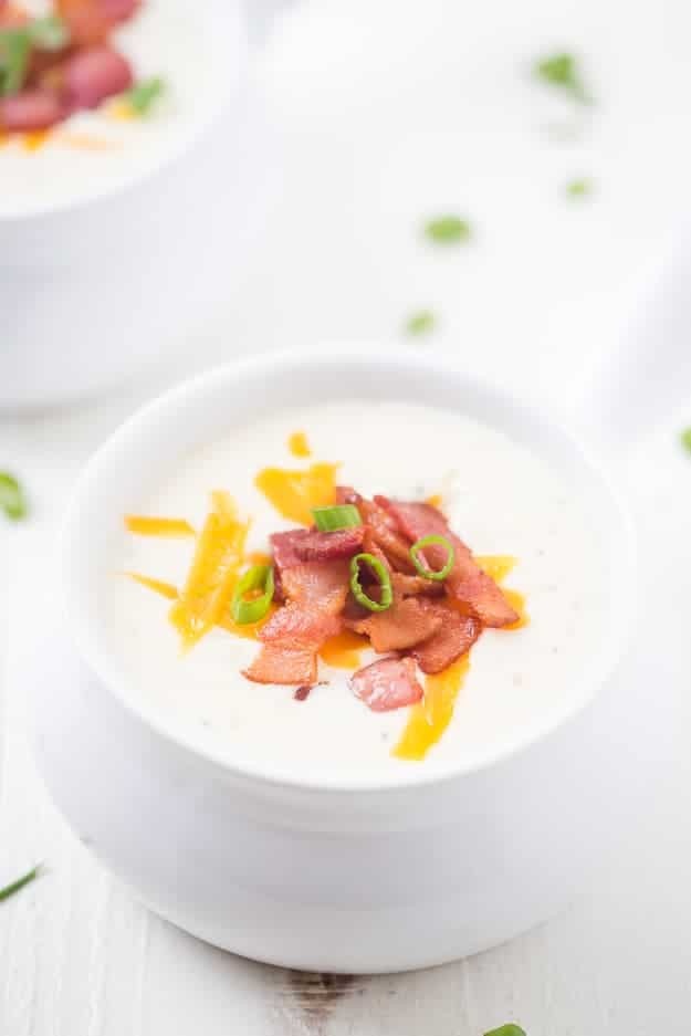 Copycat Panera Baked Potato Soup - The easiest baked potato soup ever! Diced russets potatoes are simmered in the best seasonings and spices with bacon in a rich cream sauce topped with green onions, more bacon, and shredded cheese! It's everything you want in a baked potato soup. It's rich; it's creamy and easy! Better than the original!