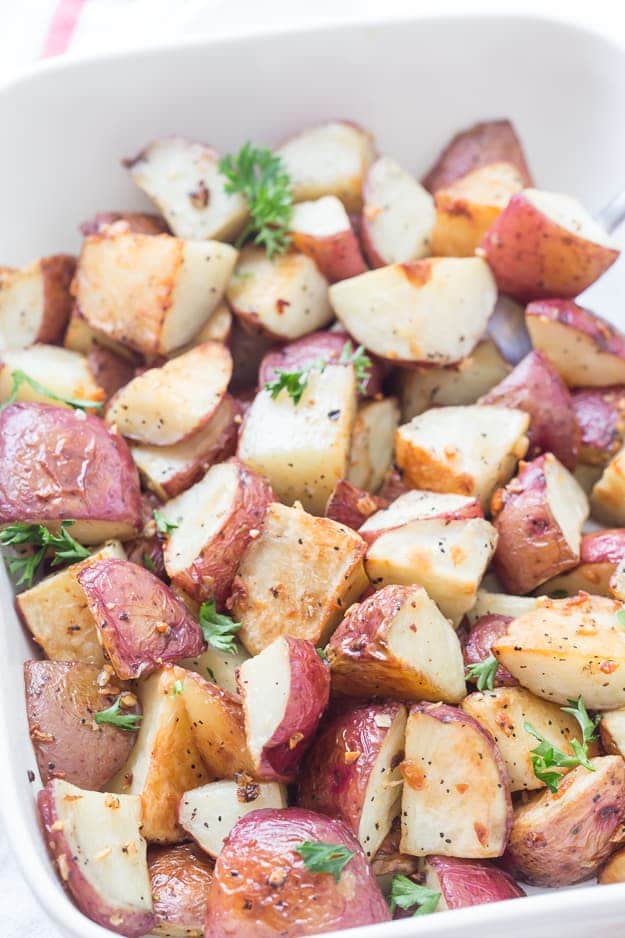 These easy Garlic Roasted Red Potatoes are full of flavor! They are crispy on the outside and oh, so tender on the inside - my favorite. Oven-roasted potatoes are a must-have for any meal!