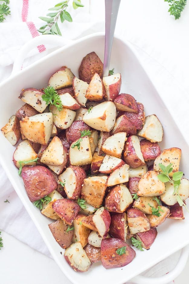 These easy Garlic Roasted Red Potatoes are full of flavor! They are crispy on the outside and oh, so tender on the inside - my favorite. Oven-roasted potatoes are a must-have for any meal!
