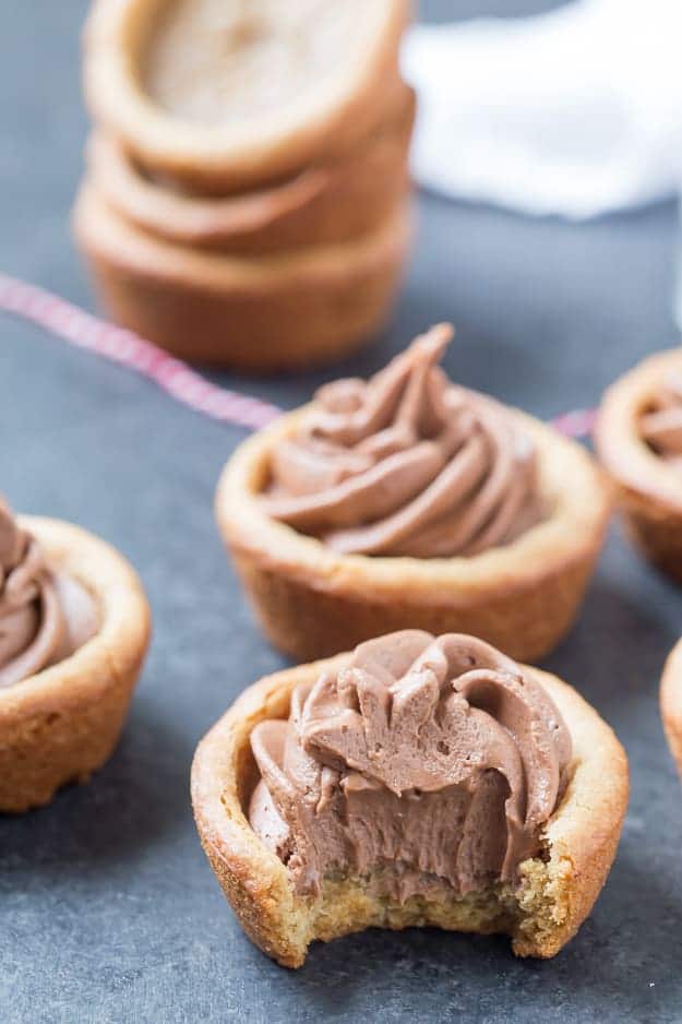 Peanut Butter Nutella Fudge Cookie Cups are so soft and fluffy and filled with an outrageous Nutella fudge frosting! Can be made in a regular muffin tin or even in a mini!