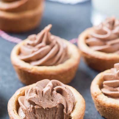 Peanut Butter Nutella Fudge Cookie Cups are so soft and fluffy and filled with an outrageous Nutella fudge frosting! Can be made in a regular muffin tin or even in a mini!
