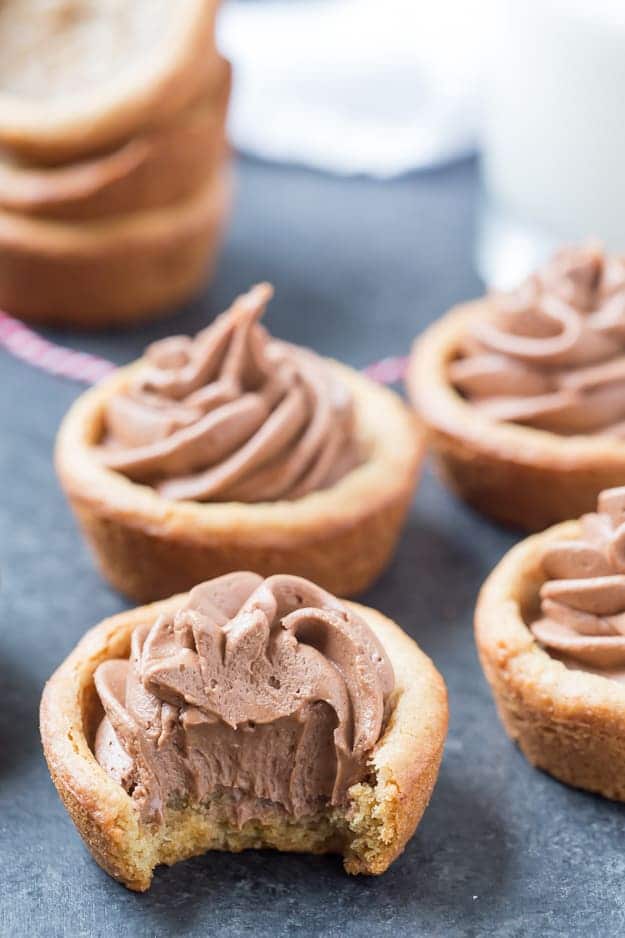 Peanut Butter Nutella Fudge Cookie Cups are so soft and fluffy and filled with an outrageous Nutella fudge frosting! Can be made in a regular muffin tin or even in a mini!