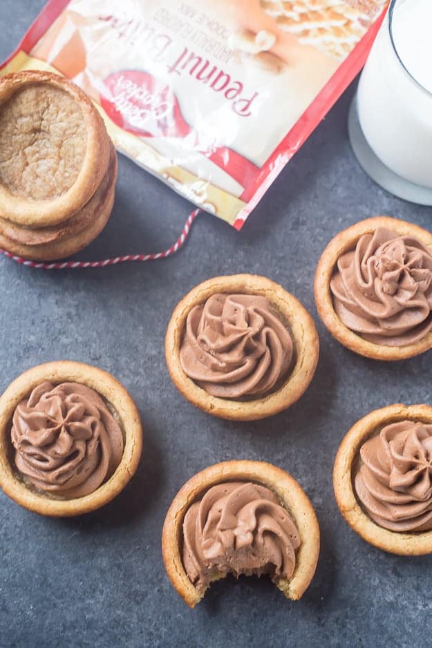 Peanut Butter Nutella Fudge Cookie Cups are so soft and fluffy and filled with an outrageous Nutella fudge frosting! Can be made in a regular muffin tin or even in a mini!