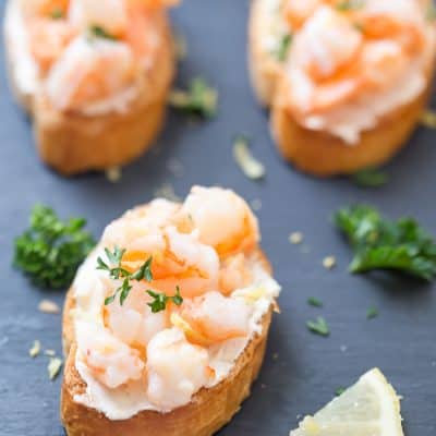 Shrimp Scampi Crostini - This shrimp scampi crostini is the perfect addition to your holiday party menu or even for game day! It's simple, it's elegant, and it has the perfect butter, lemon, garlic ratio! Impress your guests with incredibly flavorful and easy crostini.