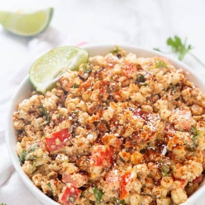 Mexican Street Corn Salad is so creamy and flavored with the perfect amount of spices, fresh lime juice, and zest, with a touch of crunch and a kick of jalapeno! Perfect all year long! 