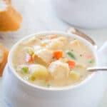 Looking at chicken pot pie soup is a soup bowl with a spoon