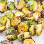 looking at air fried brussels sprouts on a white background