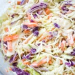 Closeup of creamy coleslaw in a glass bowl