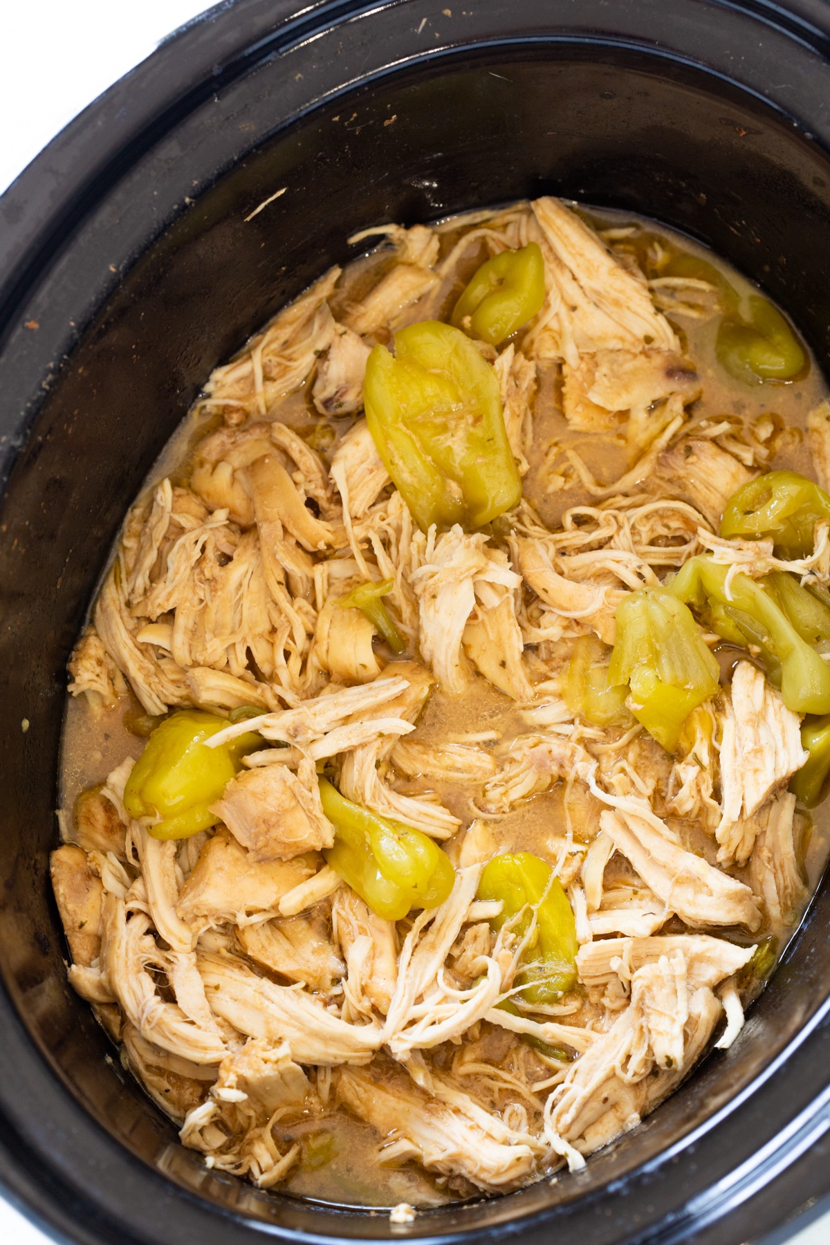 Close up of shredded shredded with pepperoncini peppers