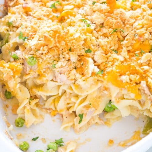 Closeup of baked tuna noodle casserole in a white casserole dish