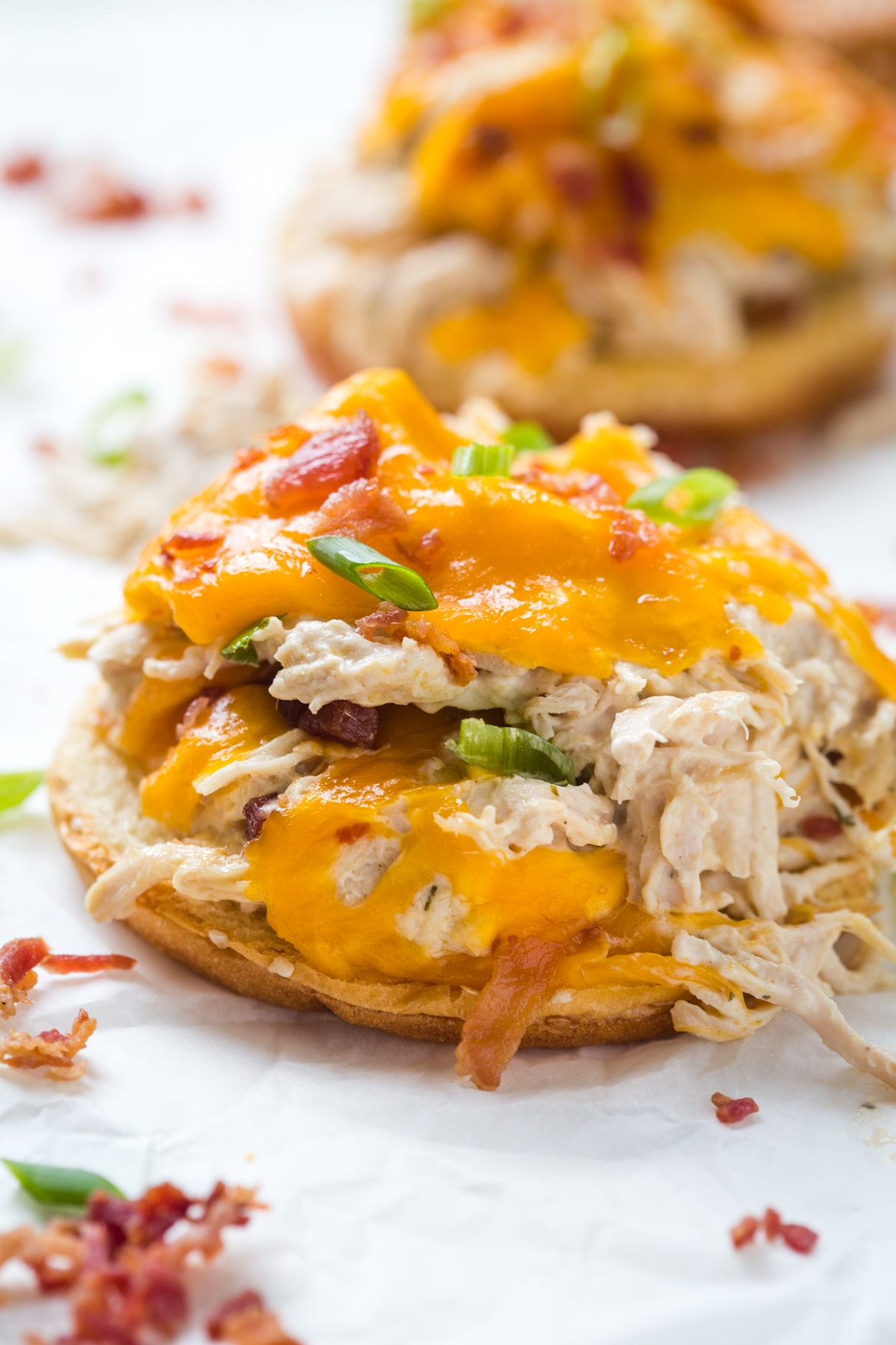 Crockpot Crack Chicken served on a bun with a white background