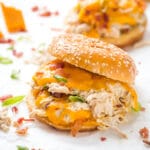 Crockpot Crack Chicken served on a bun with a white background